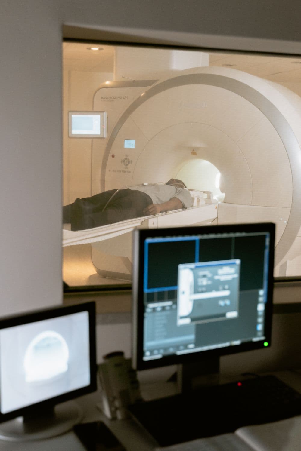 A scan on a viewing monitor beside an imaging scanner.