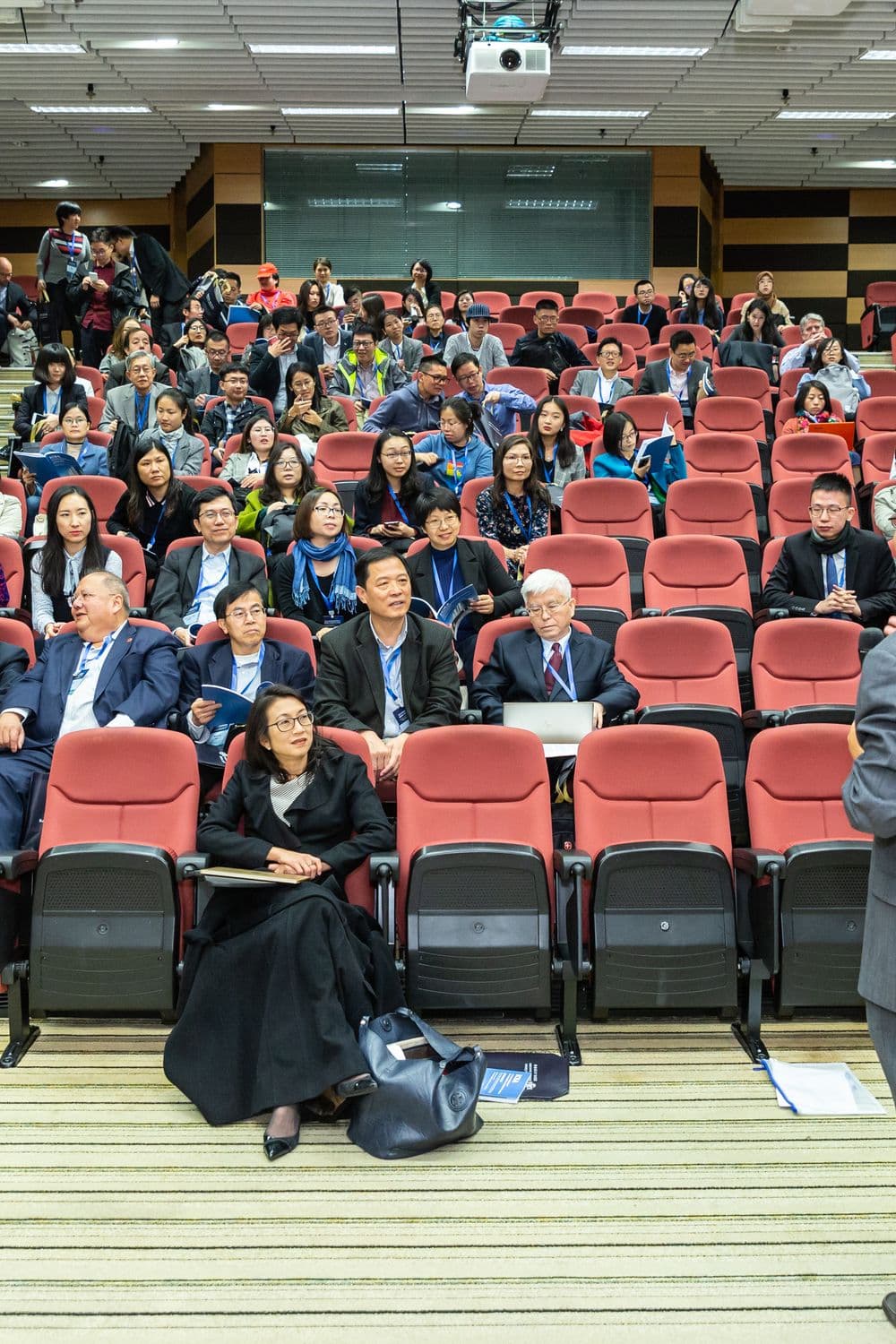 Delegates in a lecture hall following a presentation.